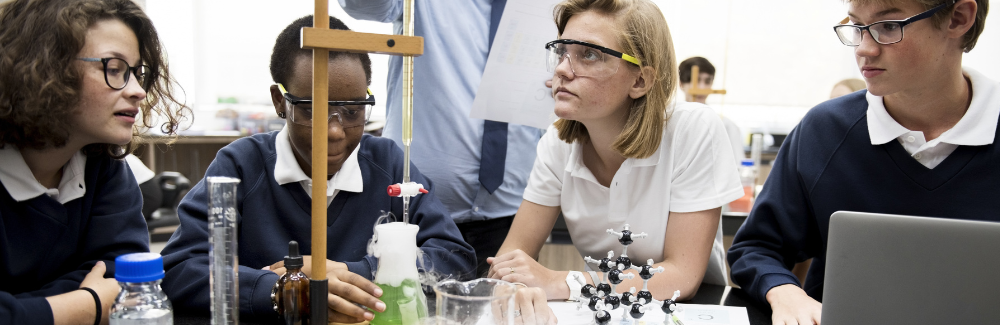Secondary Science Teacher with Students in Classroom